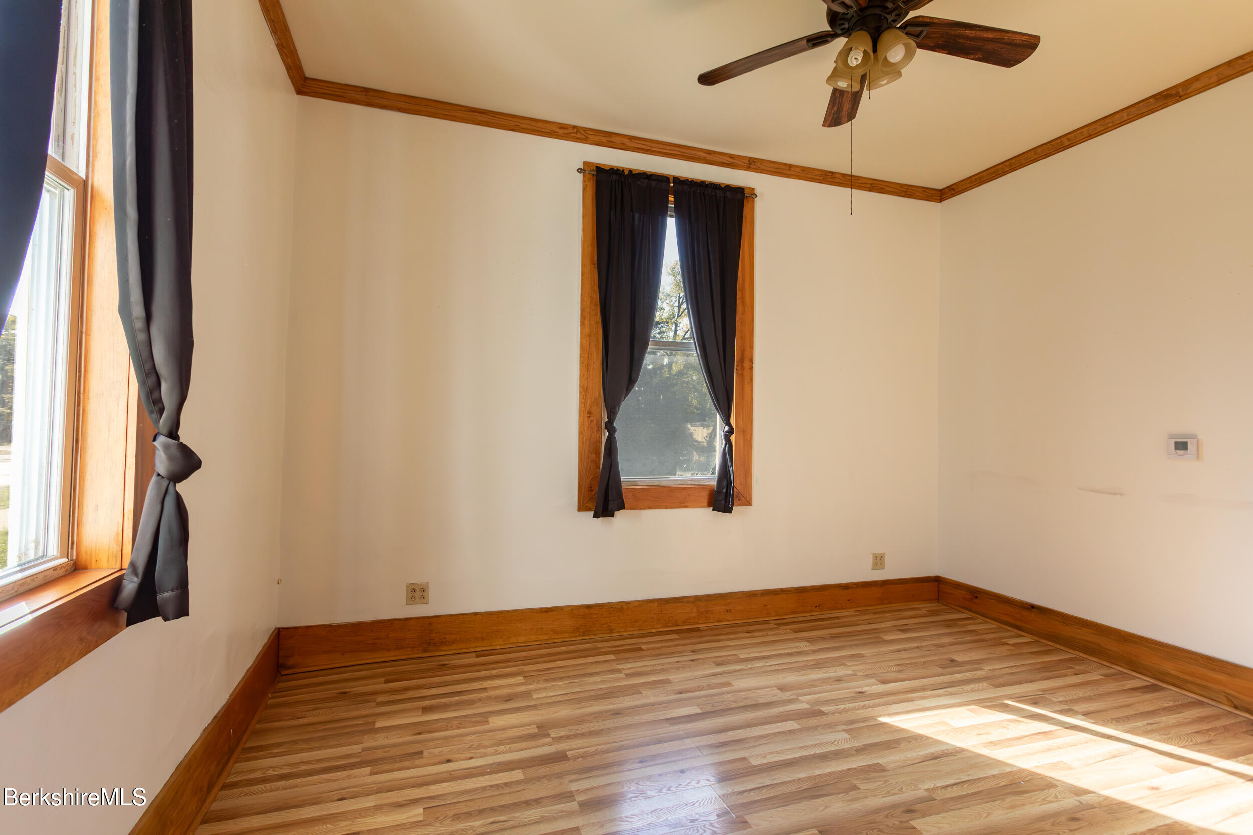 89-91 Pecks Road Pittsfield, MA 01201 - Photo 14 of 28 a view of an empty room with wooden floor and a window