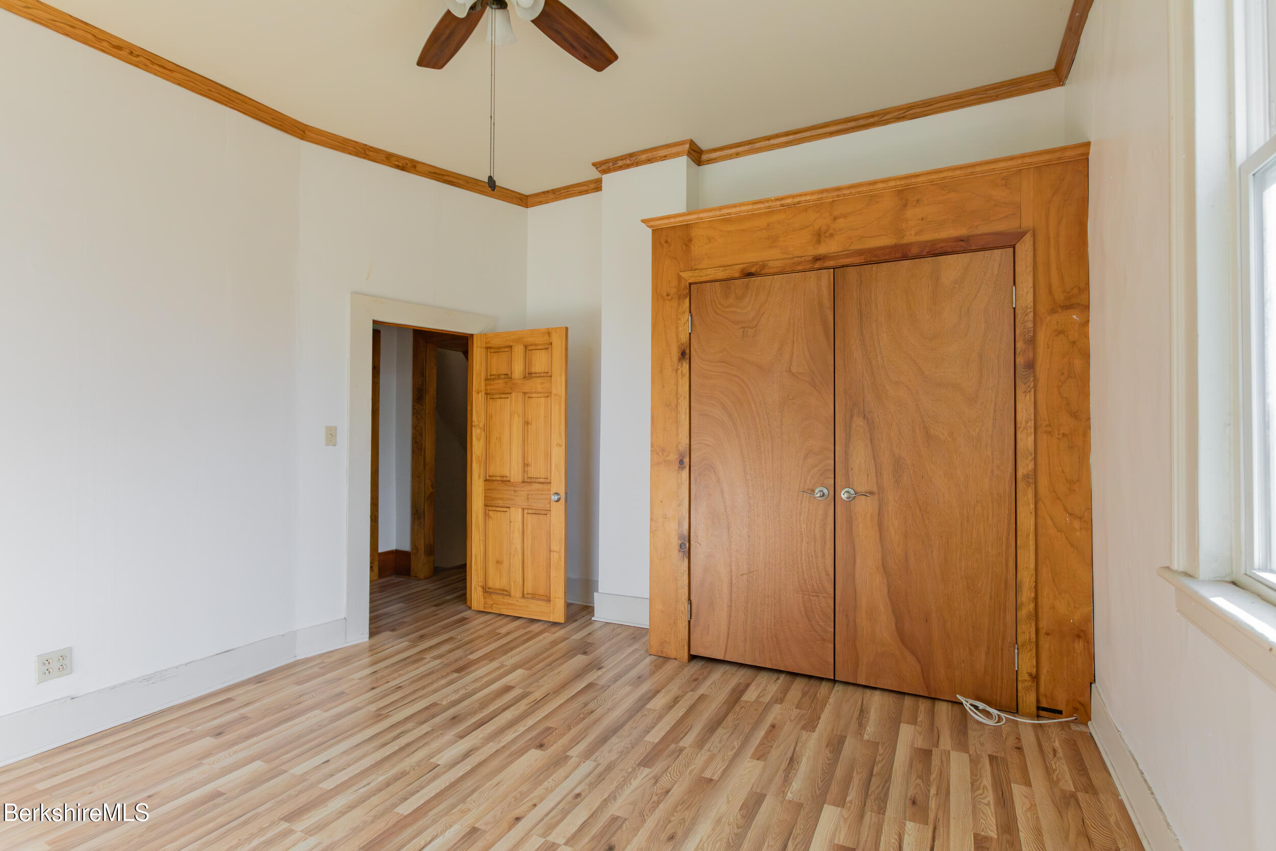 89-91 Pecks Road Pittsfield, MA 01201 - Photo 16 of 28 a view of an empty room with wooden floor and a window