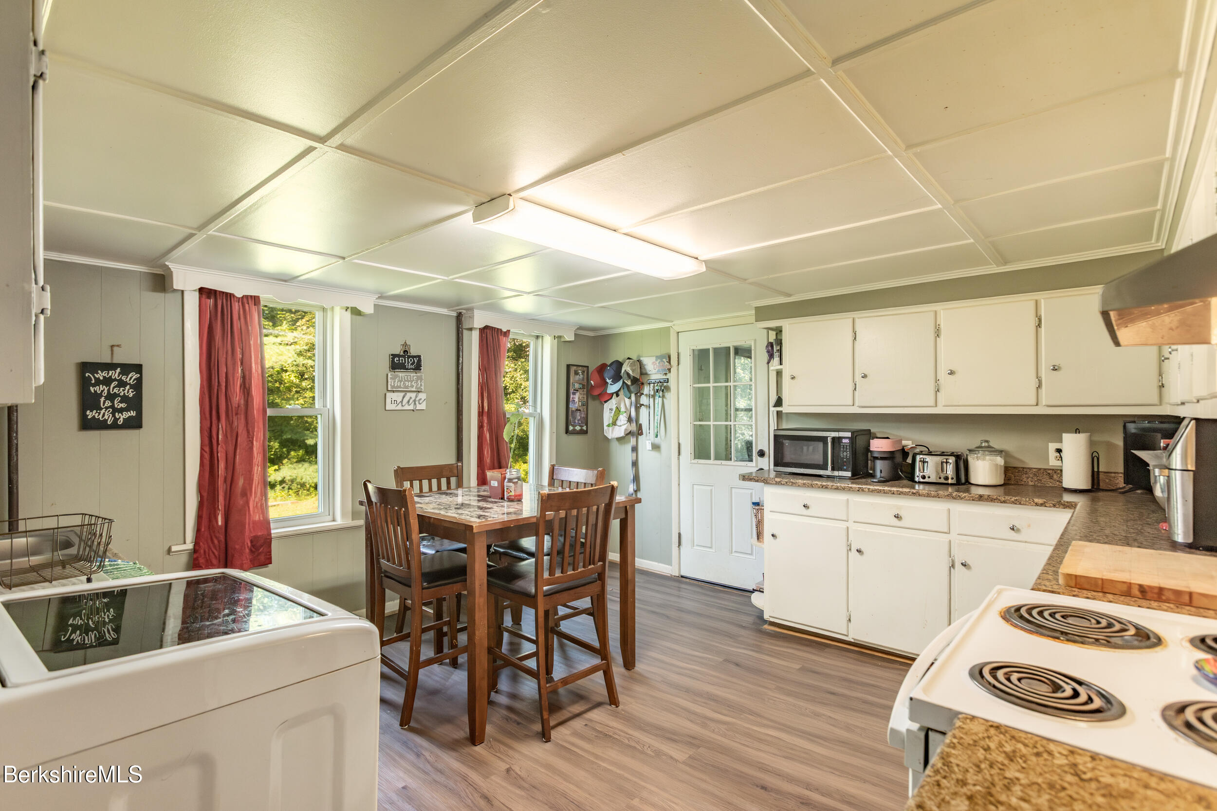 89-91 Pecks Road Pittsfield, MA 01201 - Photo 21 of 28 a kitchen with granite countertop a sink chairs and wooden cabinets