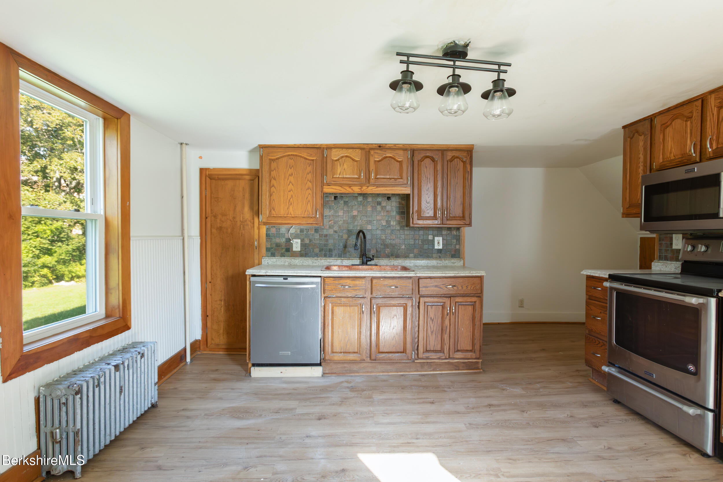 89-91 Pecks Road Pittsfield, MA 01201 - Photo 5 of 28 a kitchen with granite countertop a stove a sink and a refrigerator