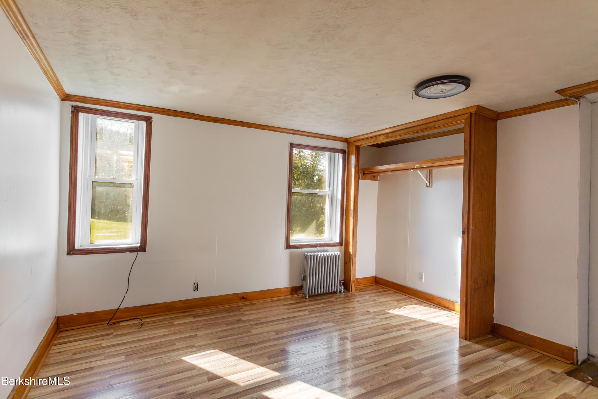 89-91 Pecks Road Pittsfield, MA 01201 - Photo 10 of 28 a view of an empty room with wooden floor and a window