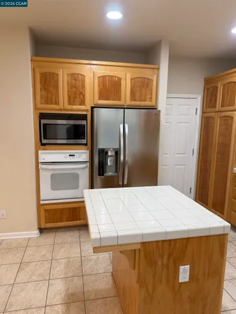 a kitchen with a refrigerator and microwave