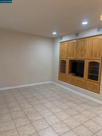 a view of an empty room with a fireplace and a window
