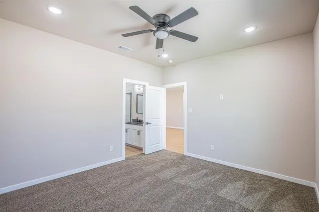 an empty room with closet and windows