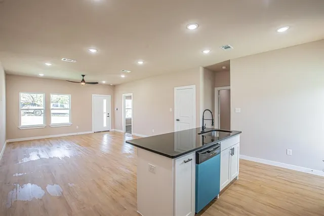 a kitchen with stainless steel appliances granite countertop a sink and a stove