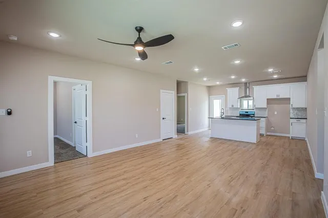 a view of a kitchen with a sink and a refrigerator