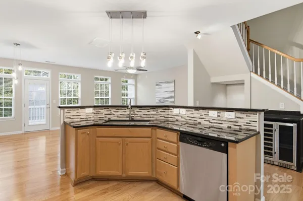 a kitchen with granite countertop a sink and cabinets