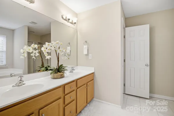 a bathroom with a double vanity sink and a mirror