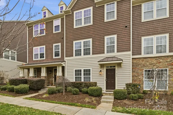 a front view of a house with yard and windows