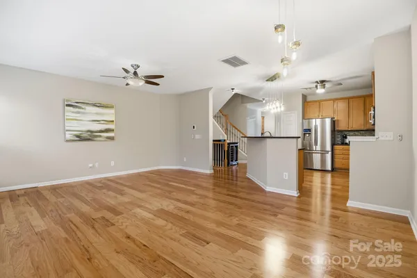 a view of a living room a kitchen and a wooden floor