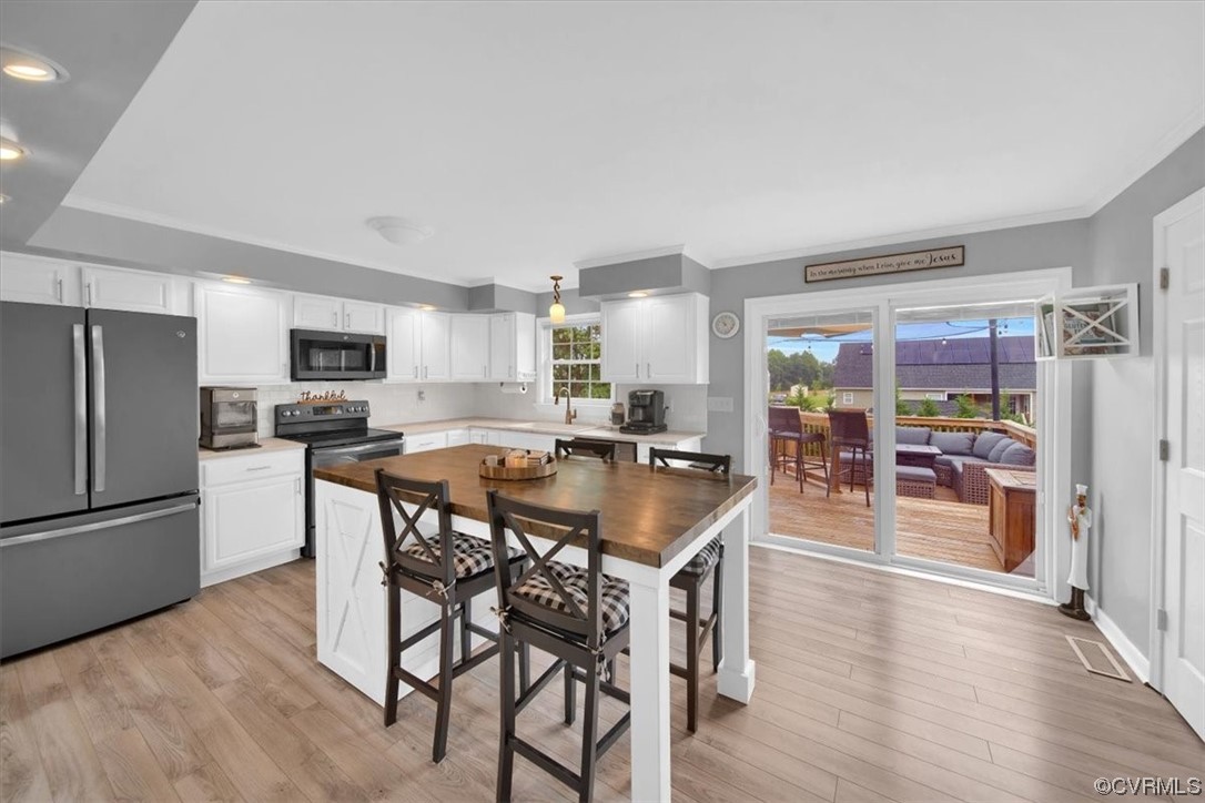 7719 Drexelbrook Road Chesterfield, VA 23832 - Photo 14 of 49 a kitchen with stainless steel appliances granite countertop a refrigerator a stove a sink a dining table and chairs with wooden floor