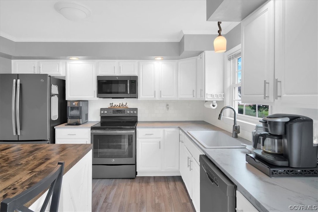 7719 Drexelbrook Road Chesterfield, VA 23832 - Photo 17 of 49 a kitchen with a sink a counter top space cabinets and stainless steel appliances