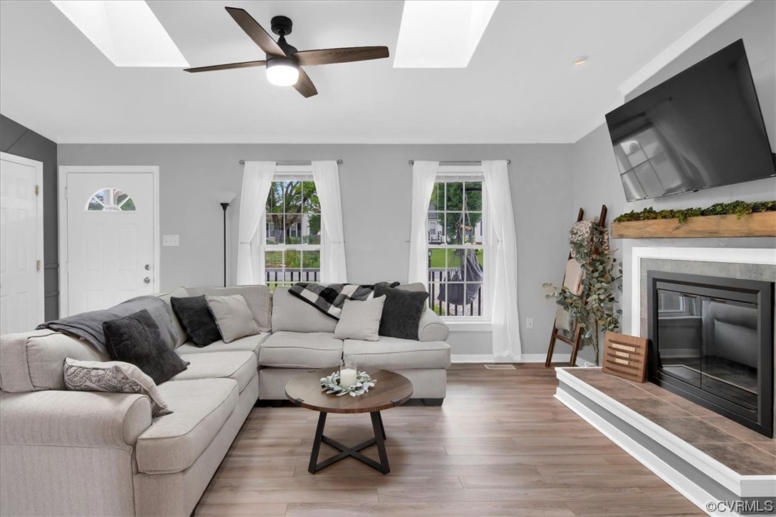 7719 Drexelbrook Road Chesterfield, VA 23832 - Photo 10 of 49 a living room with furniture a flat screen tv and a fireplace