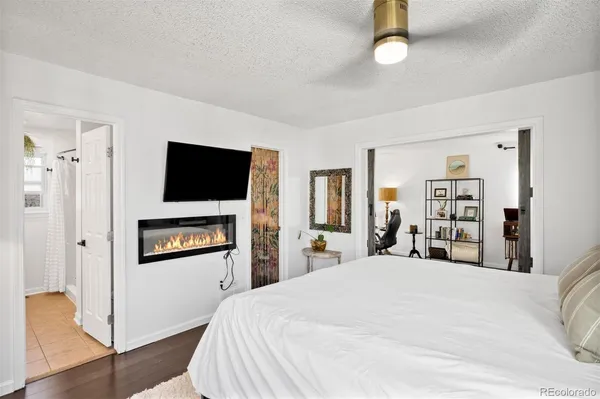 a bedroom with a bed and a flat screen tv