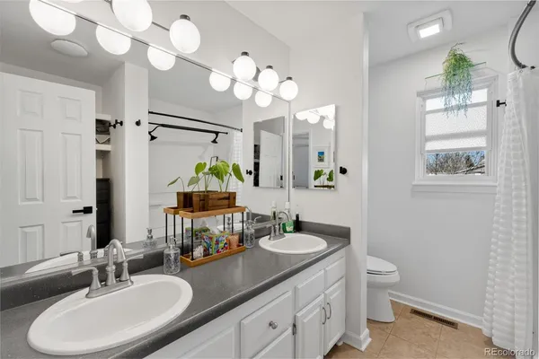 a bathroom with a sink double vanity and a mirror