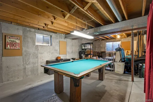 a room with pool table and mirrors