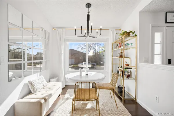 a living room with furniture a window and a chandelier