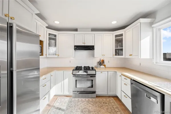a kitchen with a sink stove and refrigerator