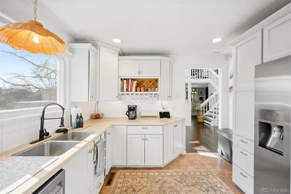 a kitchen with a sink stove and refrigerator