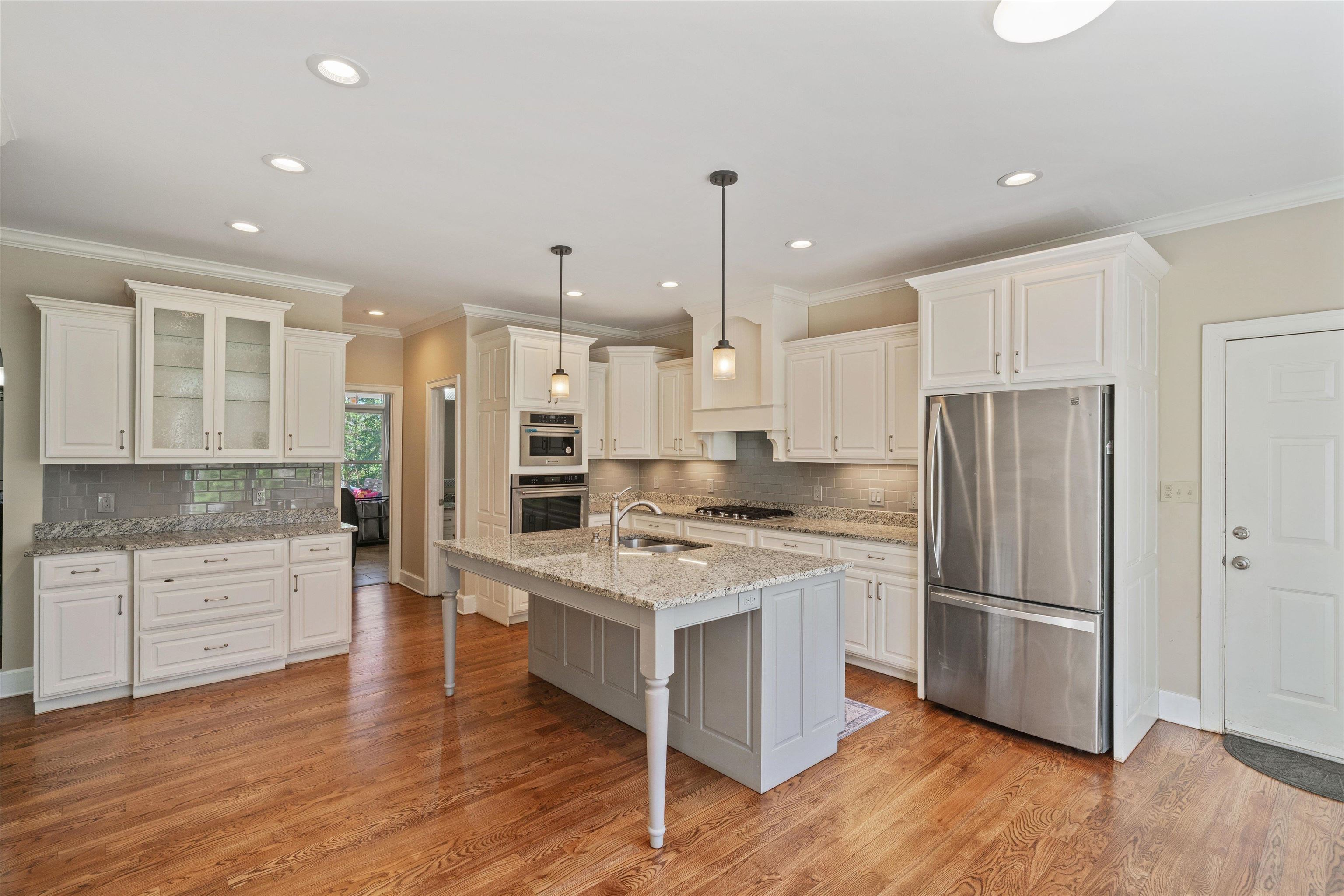 1805 Russell Road Bolivar, TN 38008 - Photo 11 of 39 Kitchen with light wood-type flooring, appliances with stainless steel finishes, white cabinets, and a sink