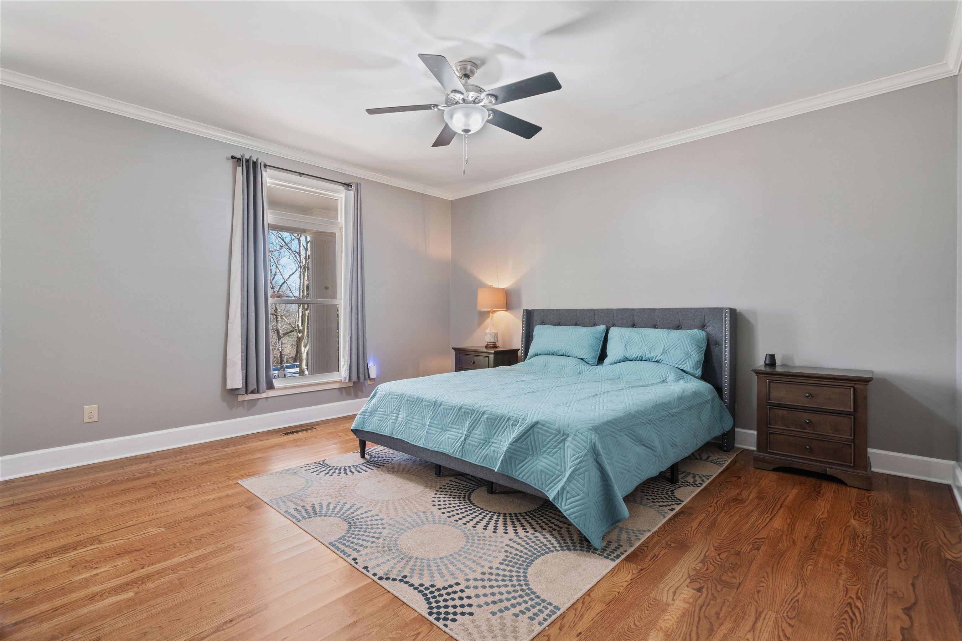 1805 Russell Road Bolivar, TN 38008 - Photo 12 of 39 Bedroom featuring visible vents, baseboards, ceiling fan, ornamental molding, and wood finished floors