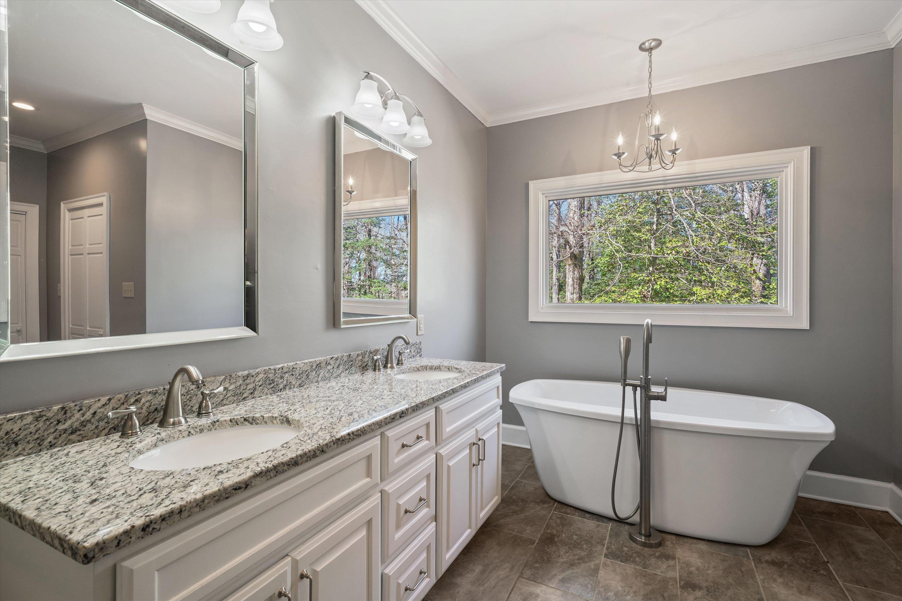 1805 Russell Road Bolivar, TN 38008 - Photo 14 of 39 Full bathroom featuring a freestanding bath, ornamental molding, and a sink