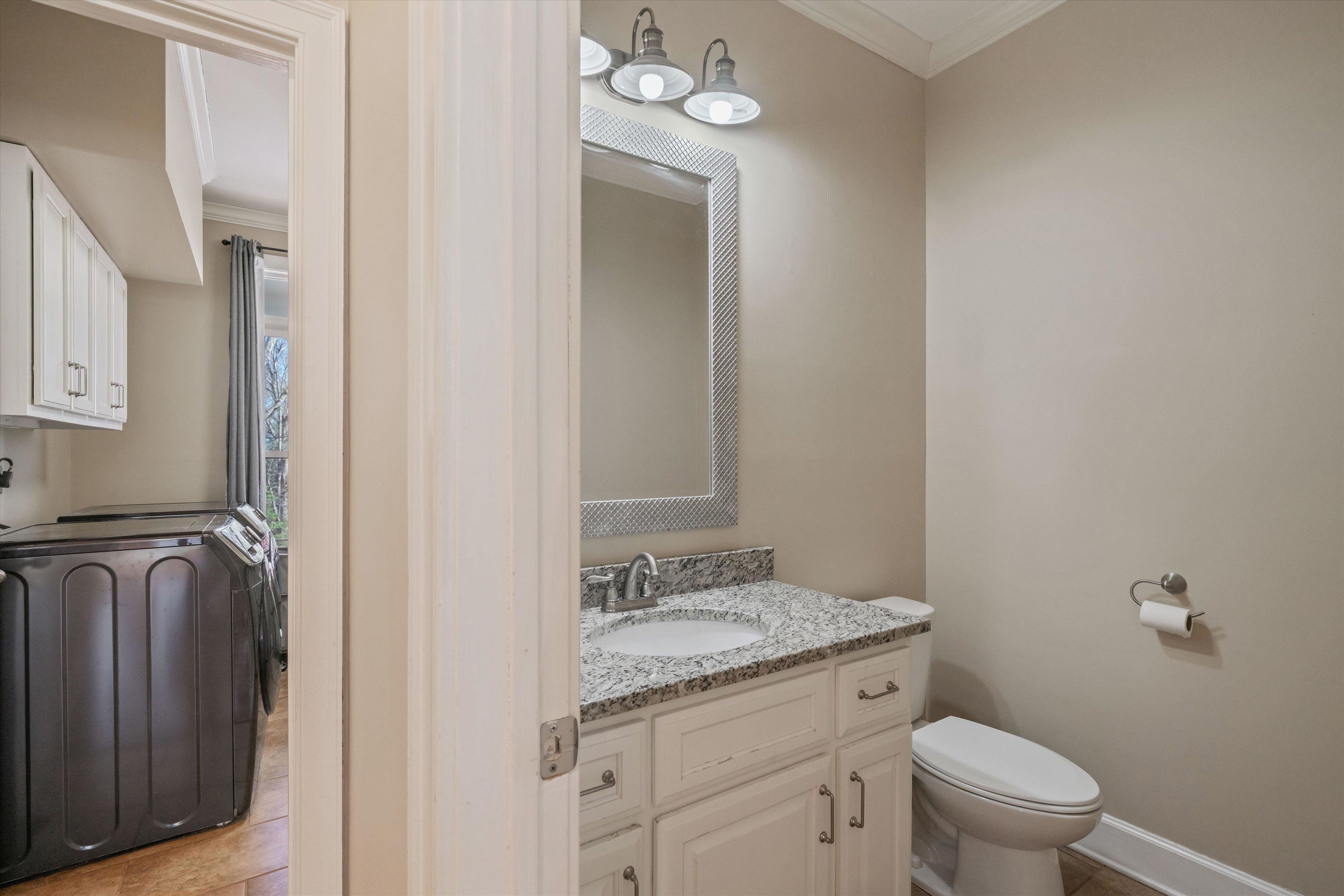 1805 Russell Road Bolivar, TN 38008 - Photo 17 of 39 Half bath featuring baseboards, vanity, toilet, and crown molding