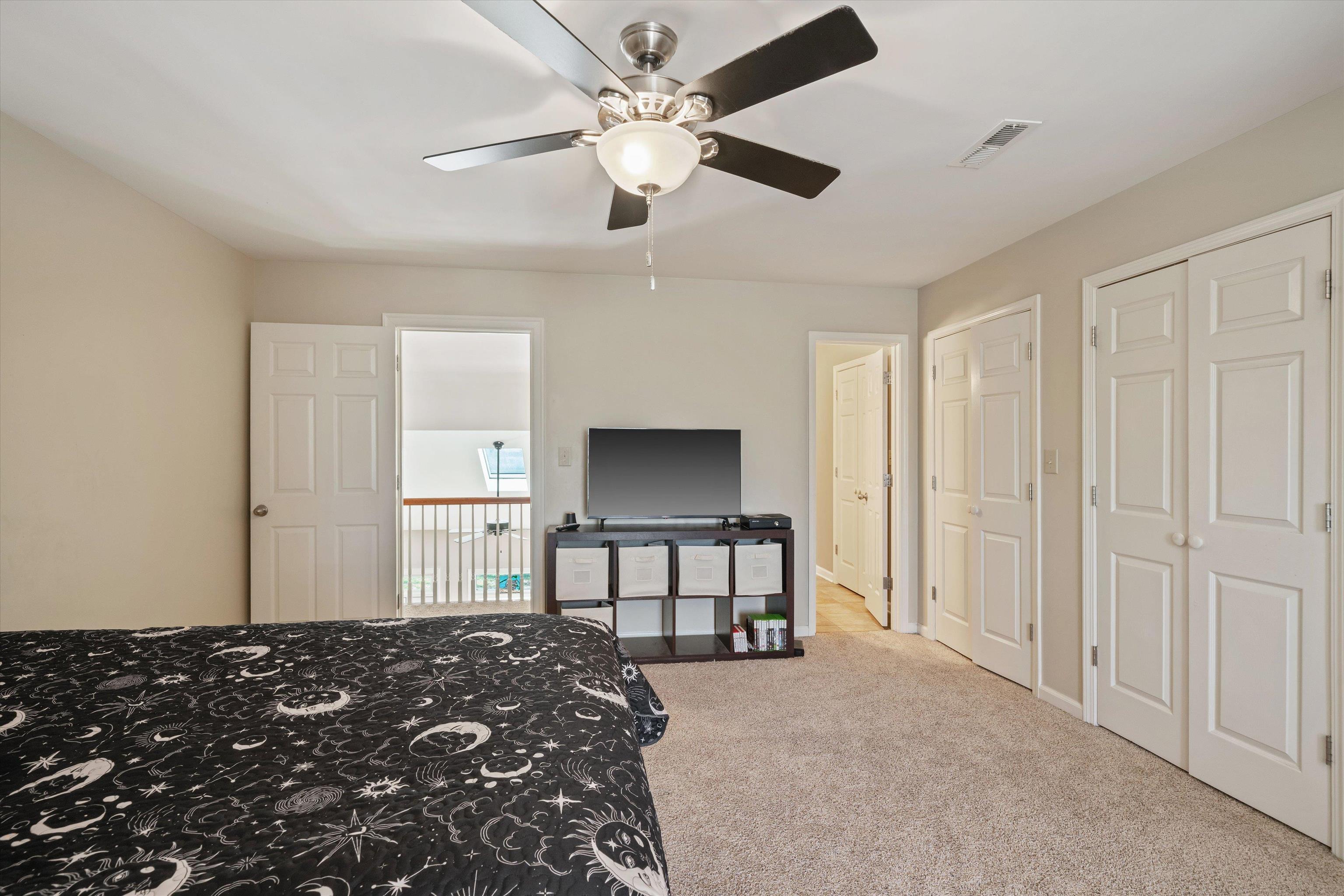 1805 Russell Road Bolivar, TN 38008 - Photo 20 of 39 Carpeted bedroom with ceiling fan, visible vents, and multiple closets