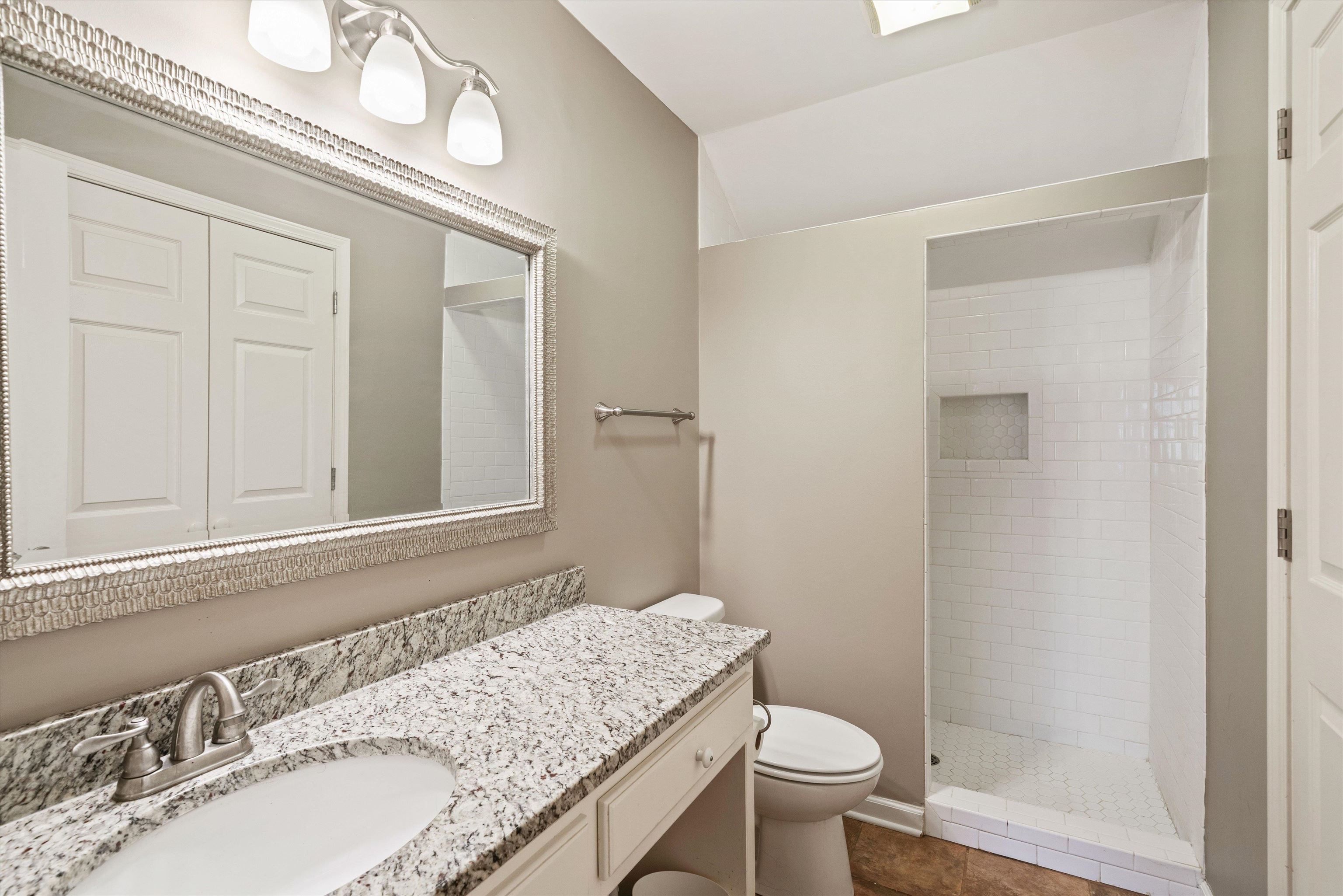1805 Russell Road Bolivar, TN 38008 - Photo 21 of 39 Full bath featuring vanity, tile patterned flooring, a shower stall, and toilet