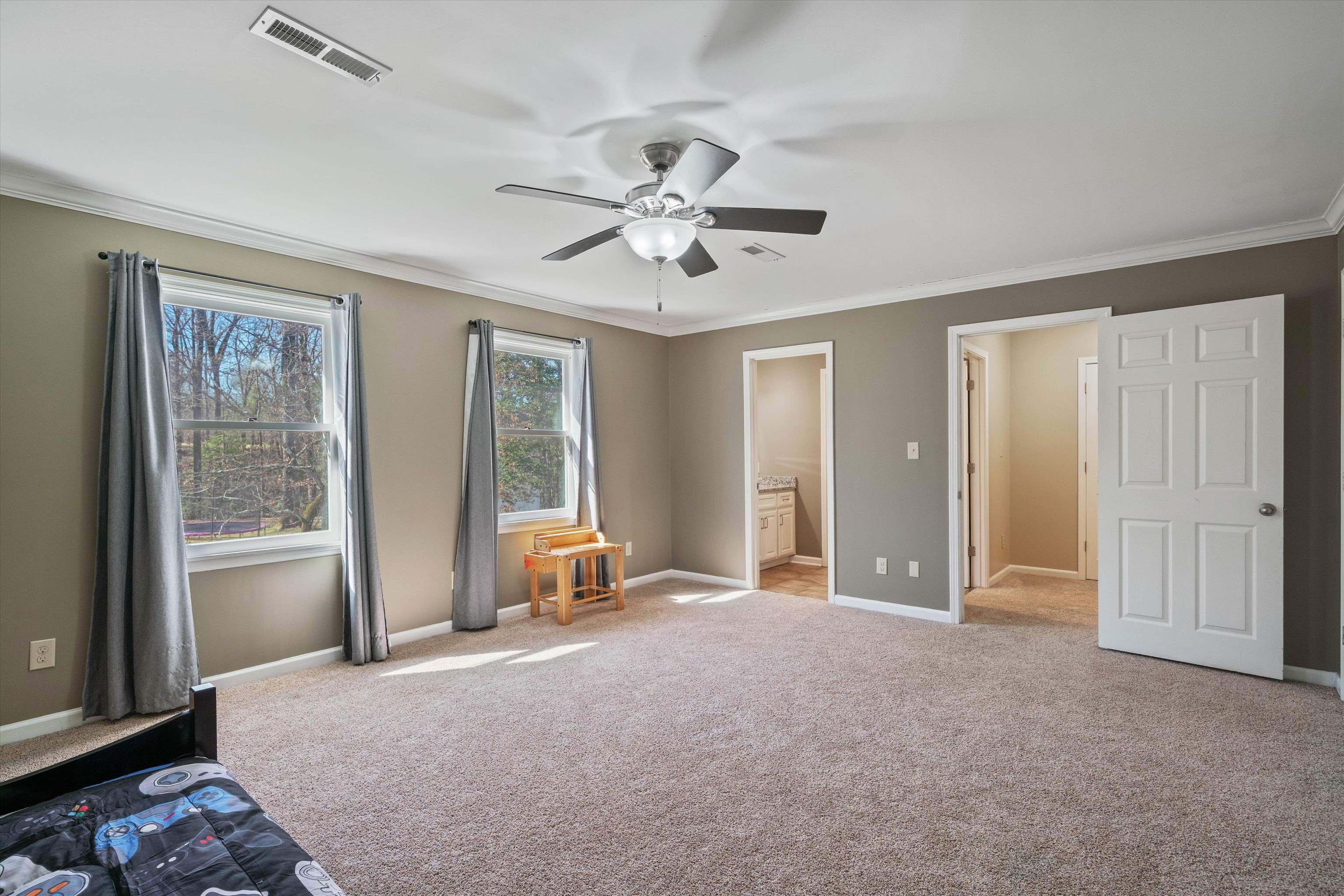 1805 Russell Road Bolivar, TN 38008 - Photo 26 of 39 Unfurnished bedroom with ornamental molding, carpet, visible vents, and baseboards