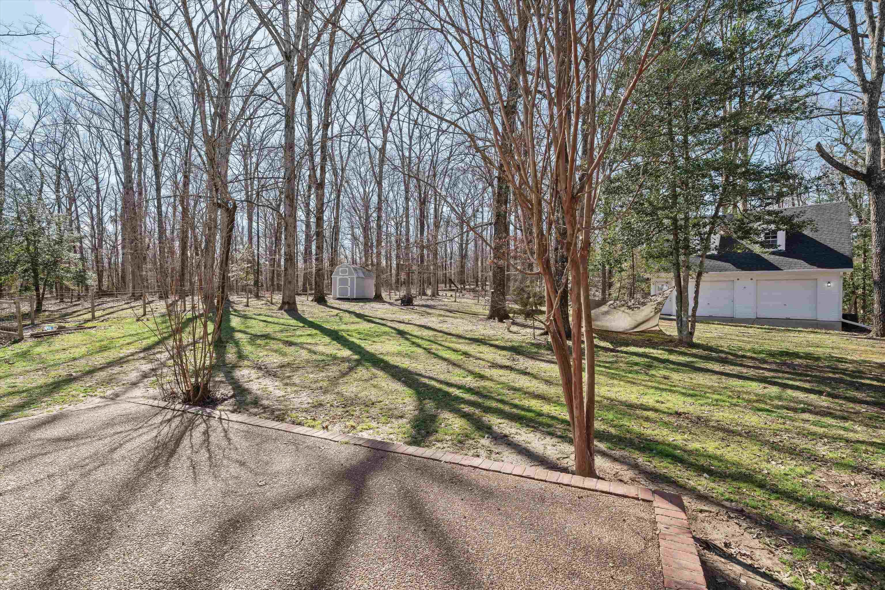 1805 Russell Road Bolivar, TN 38008 - Photo 28 of 39 View of yard with a garage, an outdoor structure, and a storage shed