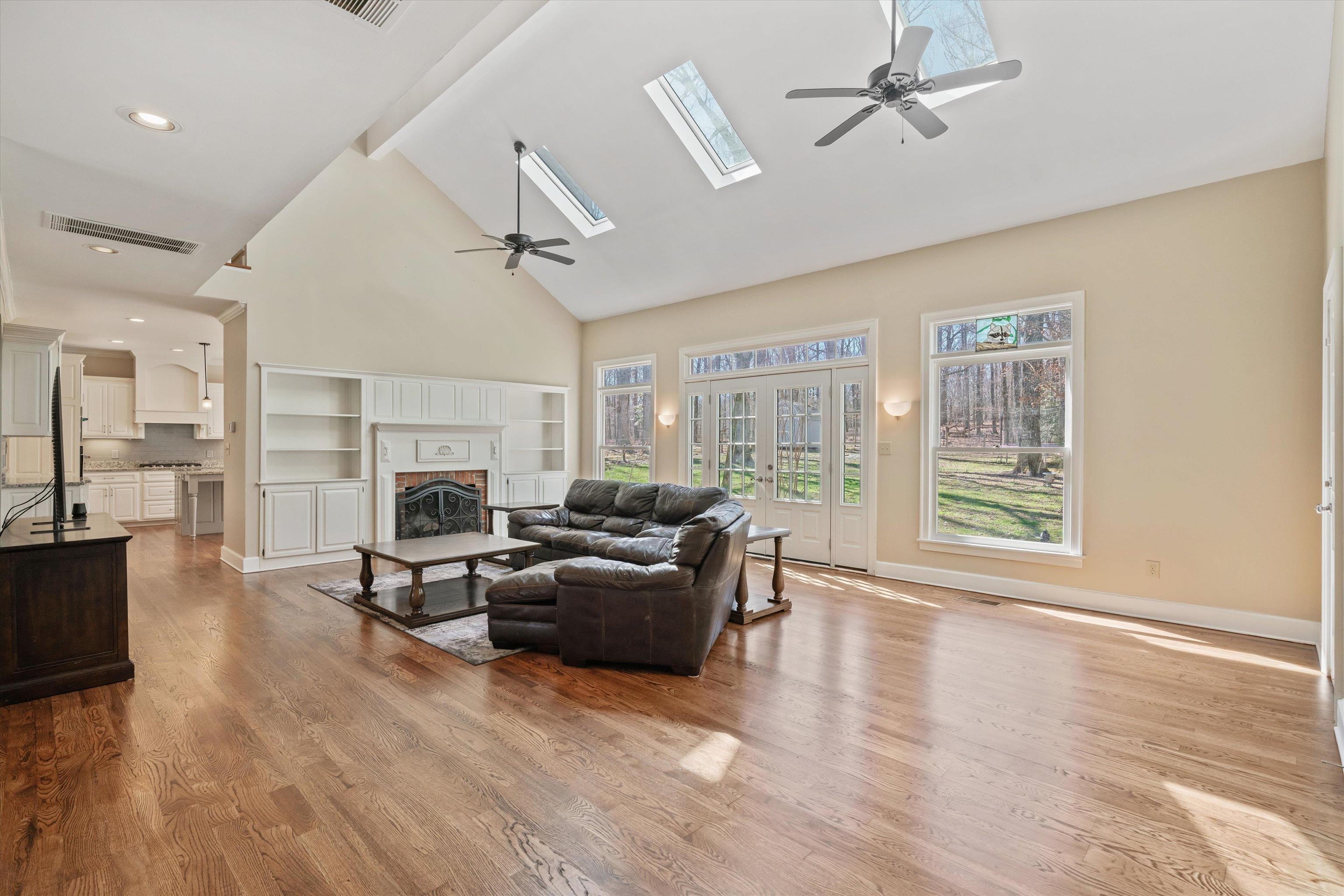 1805 Russell Road Bolivar, TN 38008 - Photo 5 of 39 Living room featuring a fireplace, visible vents, wood finished floors, and beamed ceiling