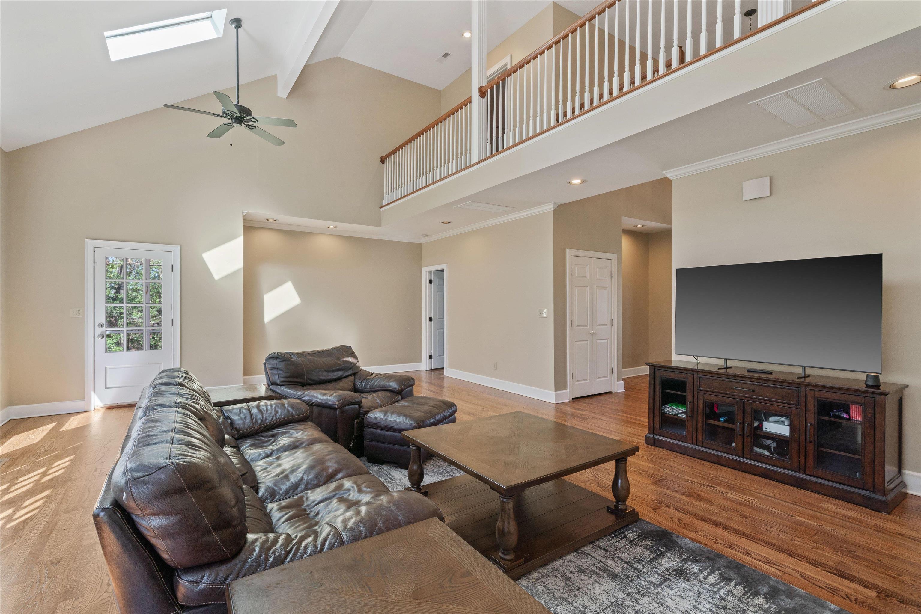 1805 Russell Road Bolivar, TN 38008 - Photo 7 of 39 Living area with a skylight, baseboards, and wood finished floors