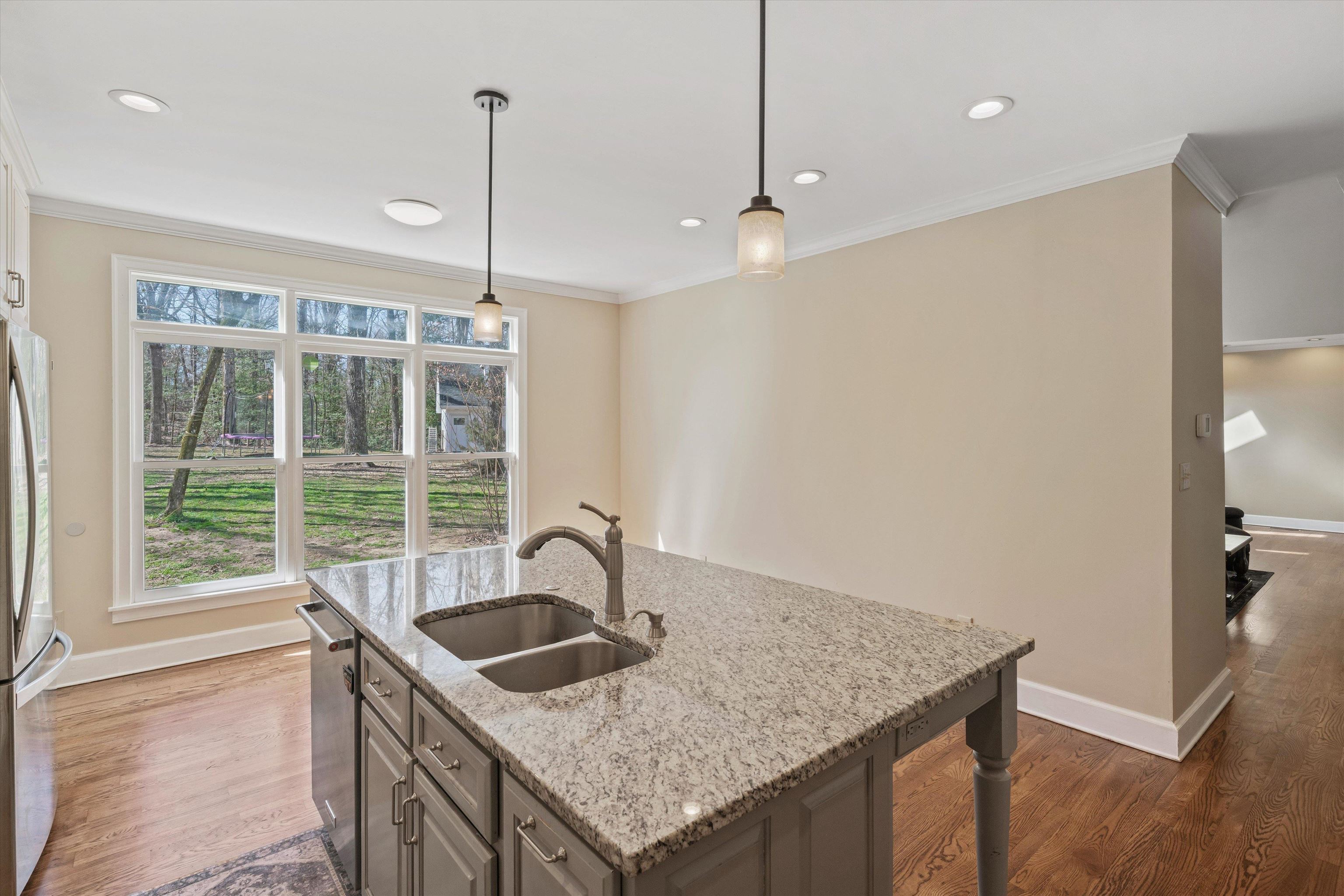 1805 Russell Road Bolivar, TN 38008 - Photo 9 of 39 Kitchen with appliances with stainless steel finishes, dark wood finished floors, a sink, and ornamental molding
