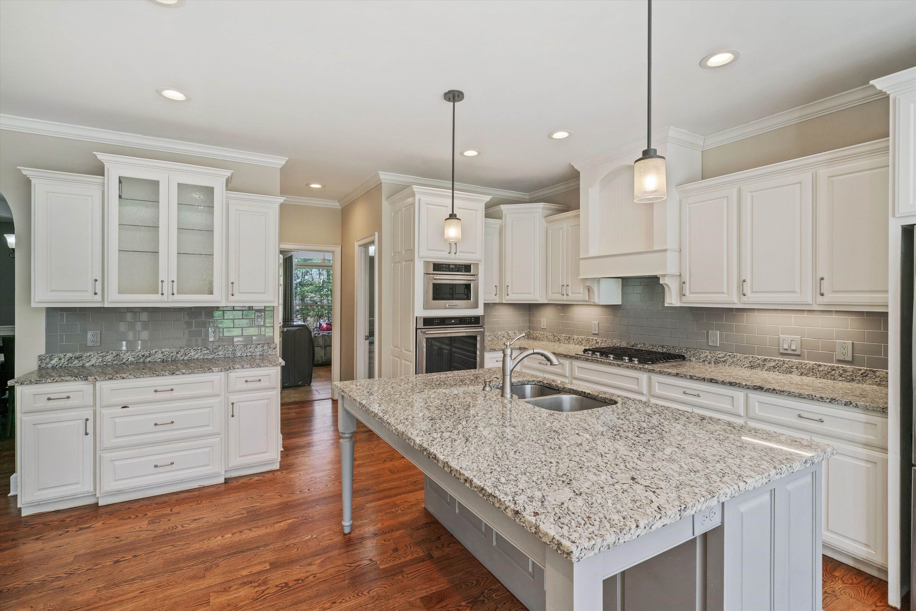 1805 Russell Road Bolivar, TN 38008 - Photo 10 of 39 Kitchen featuring appliances with stainless steel finishes, dark wood-style flooring, a sink, and white cabinetry