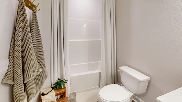 a bathroom with a toilet and a shower