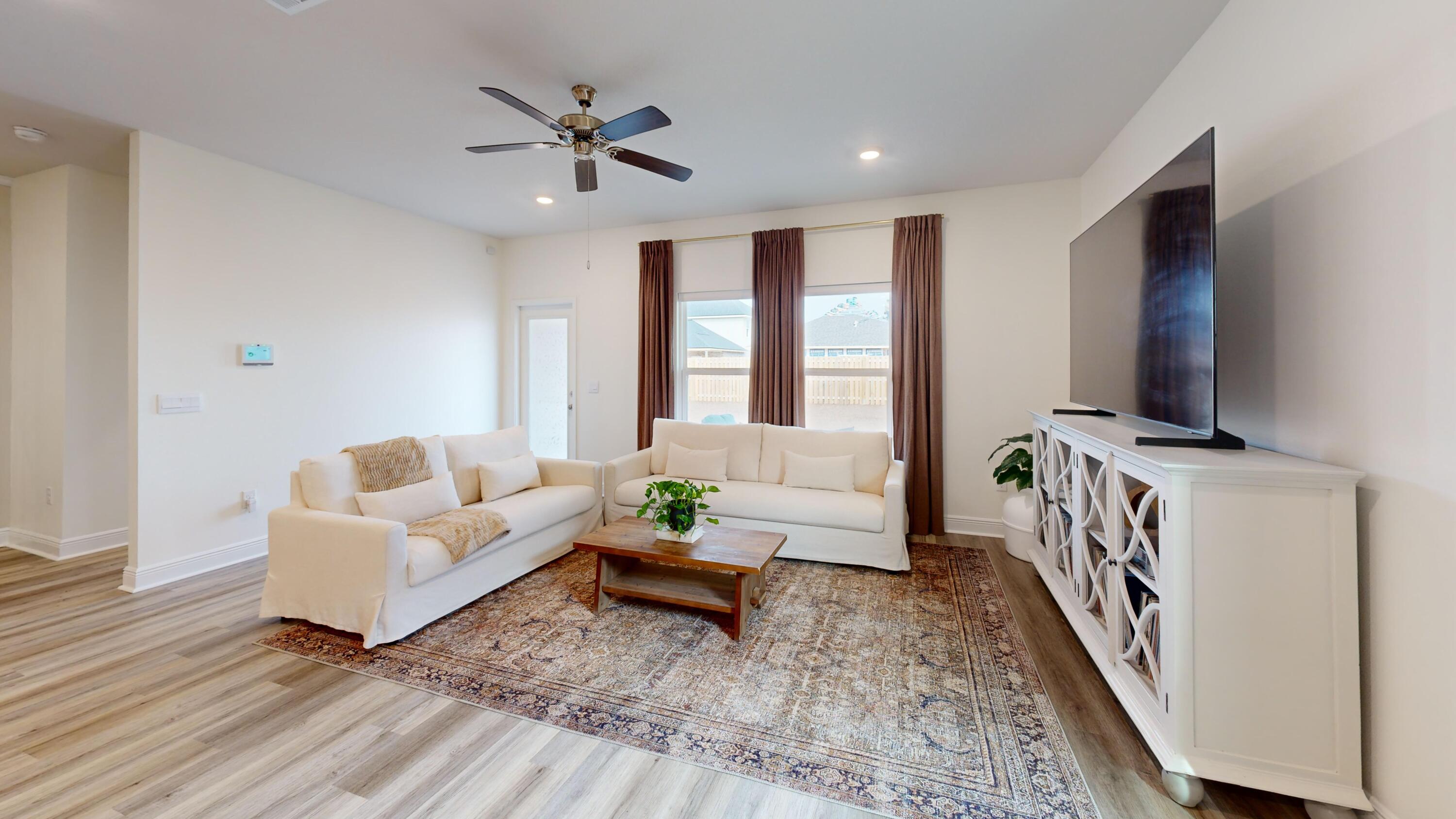 8130 Fir Tree Drive Milton, FL 32583 - Photo 5 of 17 a living room with furniture and a flat screen tv