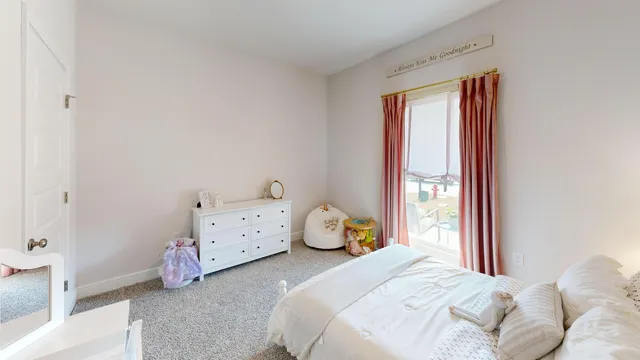 a bed room with a bed and a chair