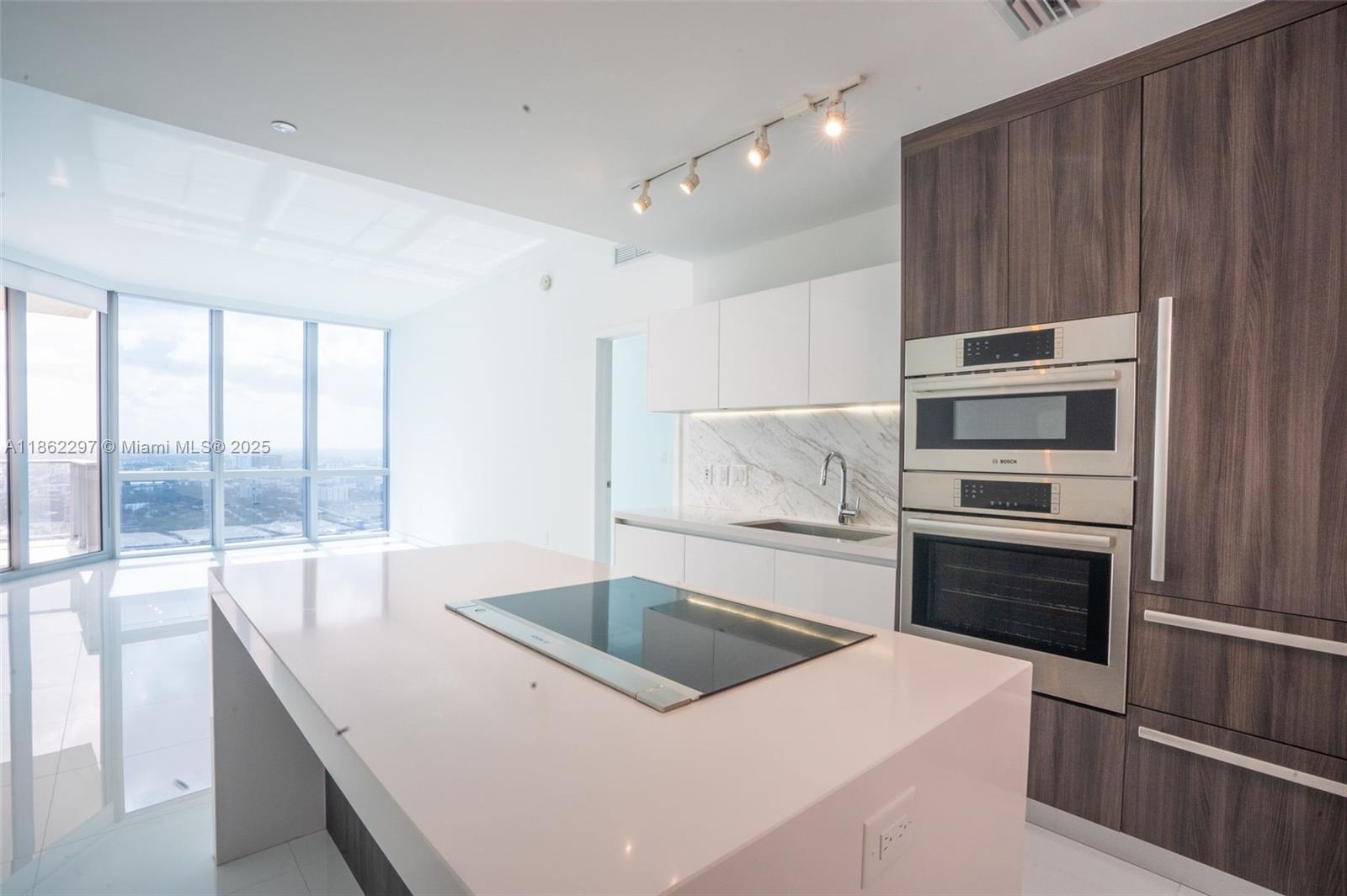 Park West Miami, FL 33132 - Photo 8 of 20 a kitchen that has a sink and a stove top oven