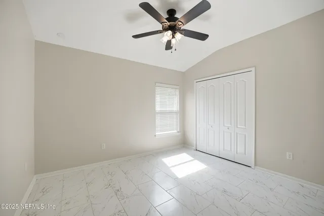 a bed room with a bed and a large window