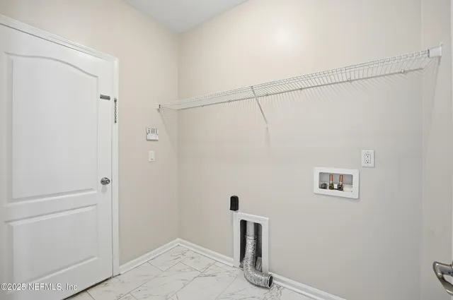a view of a room with furniture and a ceiling fan
