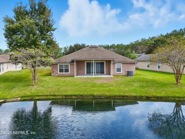 an aerial view of a house with a yard