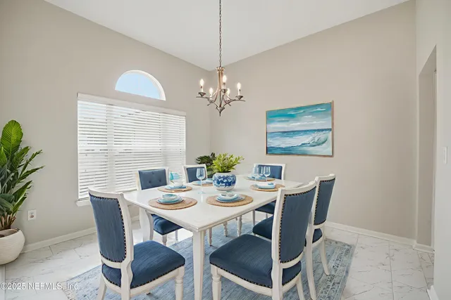 en empty room with kitchen view and wooden floor