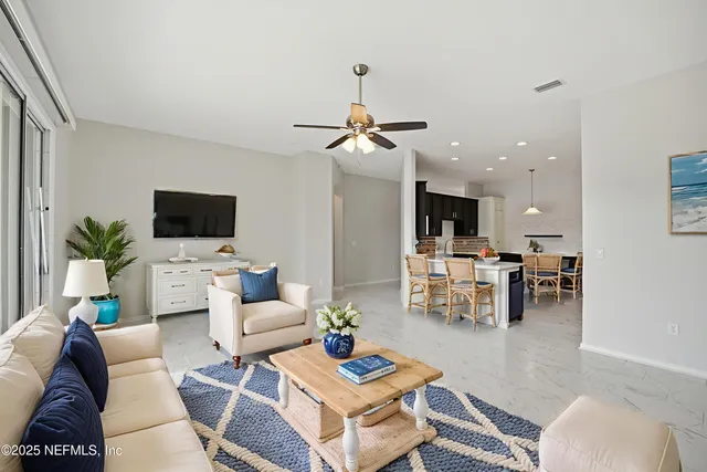 a large kitchen with a sink a counter top stainless steel appliances and cabinets