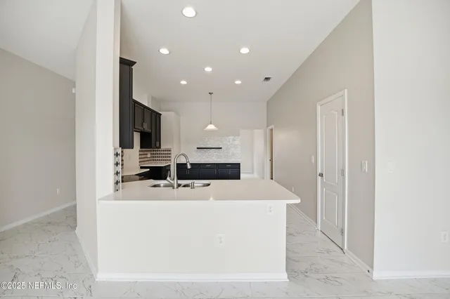 a kitchen with stainless steel appliances granite countertop a stove a sink dishwasher a refrigerator and a microwave