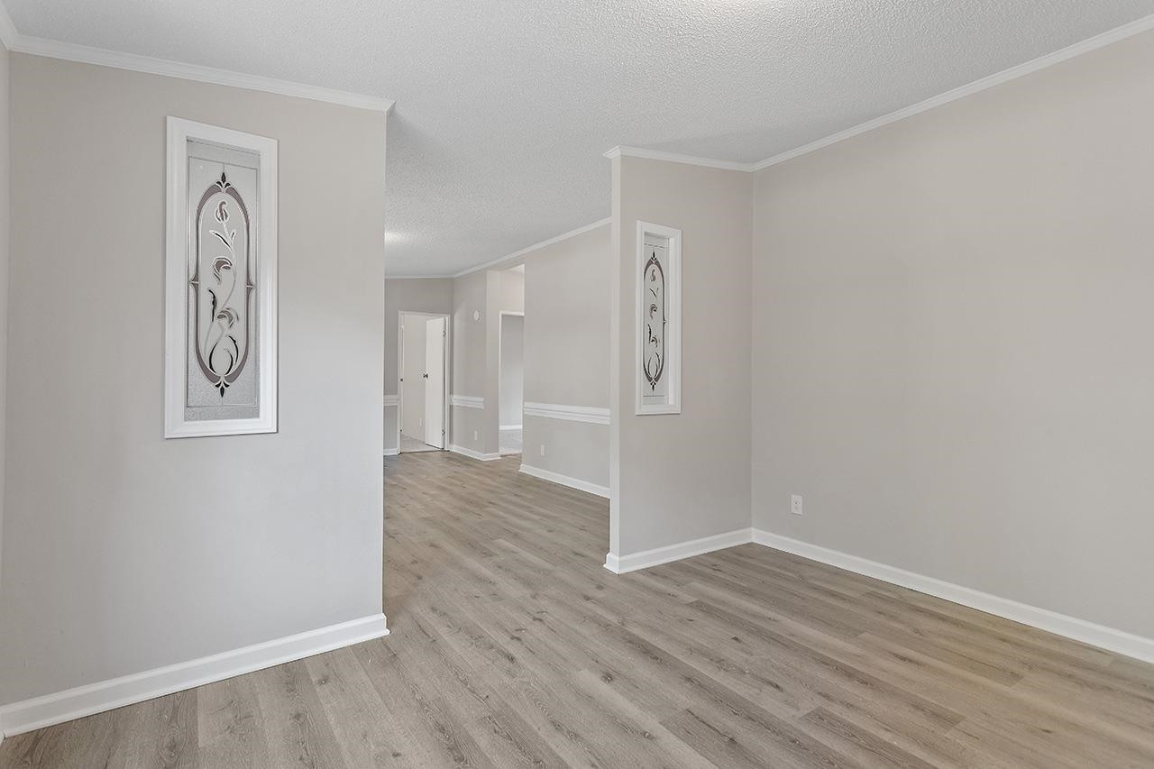 8401 South Creek Road Willow Spring, NC 27592 - Photo 11 of 24 an empty room with wooden floor and window