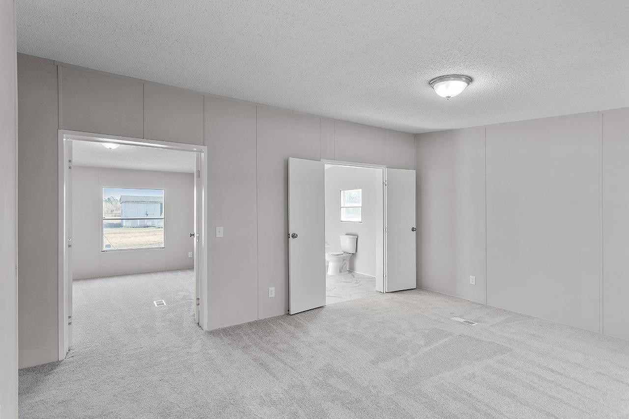 8401 South Creek Road Willow Spring, NC 27592 - Photo 13 of 24 an empty room with windows and closet