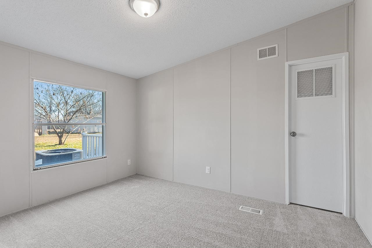 8401 South Creek Road Willow Spring, NC 27592 - Photo 14 of 24 an empty room with windows and closet