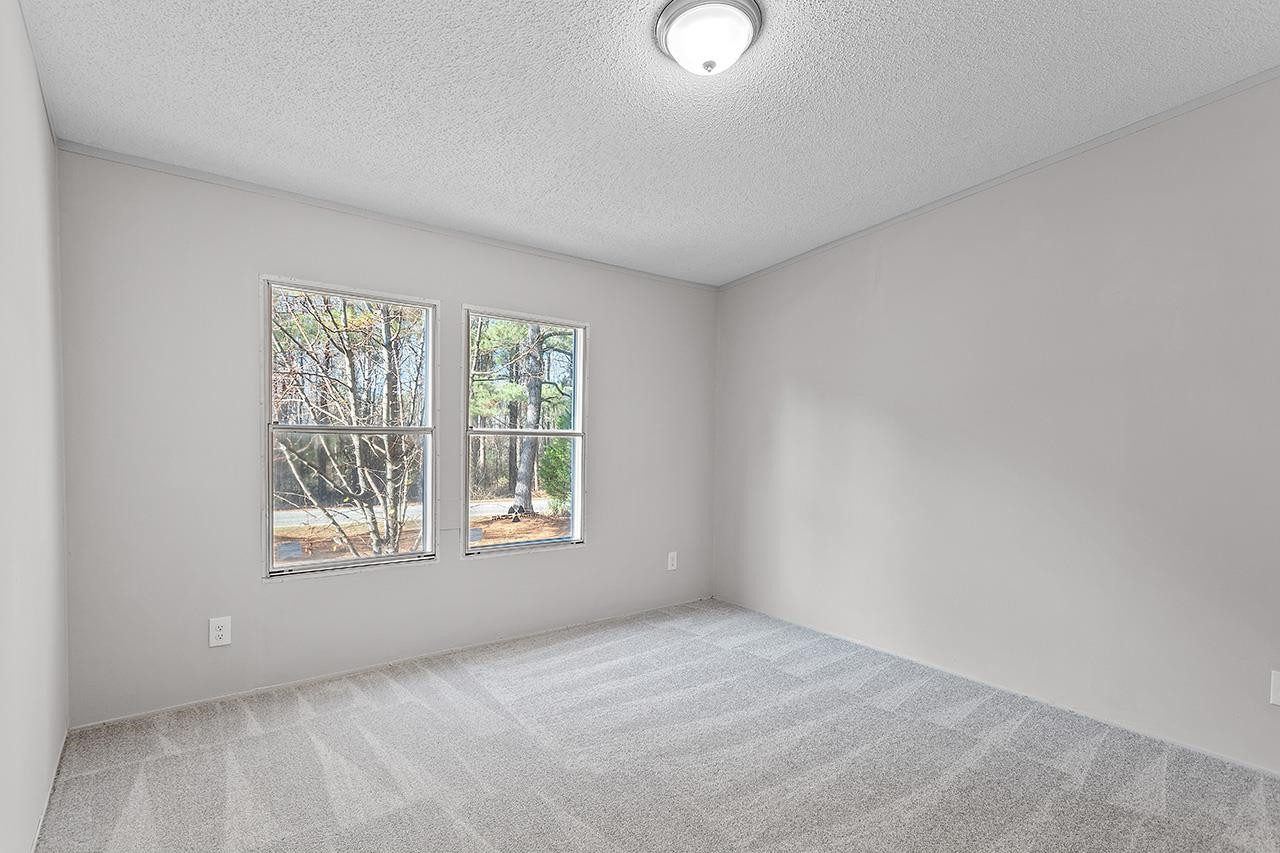 8401 South Creek Road Willow Spring, NC 27592 - Photo 15 of 24 an empty room with a window