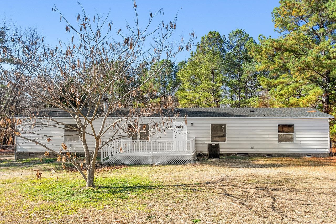 8401 South Creek Road Willow Spring, NC 27592 - Photo 19 of 24 a view of a house with a yard